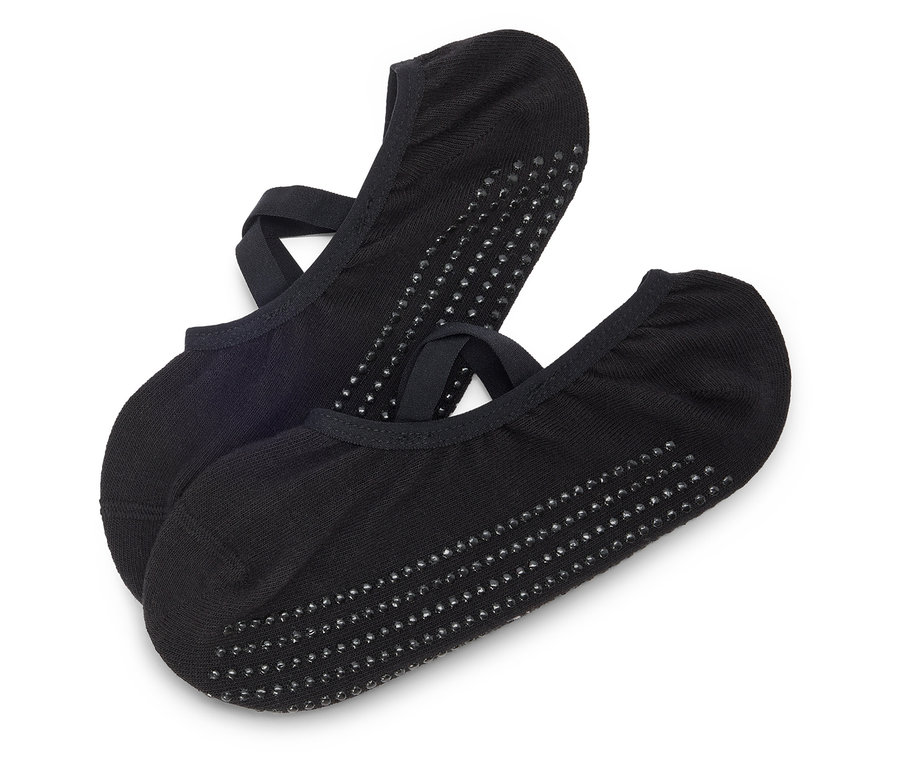 Deux chaussettes noires avec des brides et des picots sont posées l'une sur l'autre sur un fond blanc.