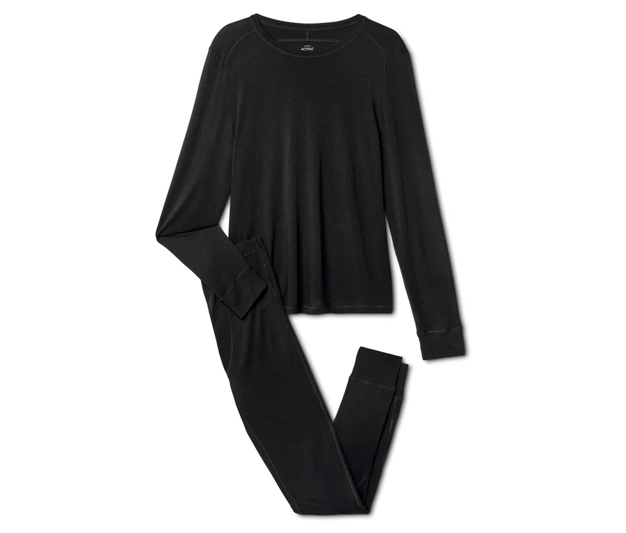 Pyjama noir à manches longues, composé d'un haut et d'un pantalon, sur fond blanc.