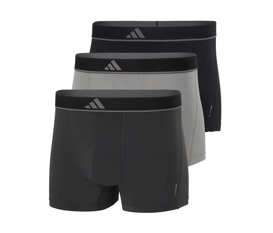 Trois boxers pour hommes en noir, gris clair et gris foncé, empilés avec des ceintures noires et un logo gris.