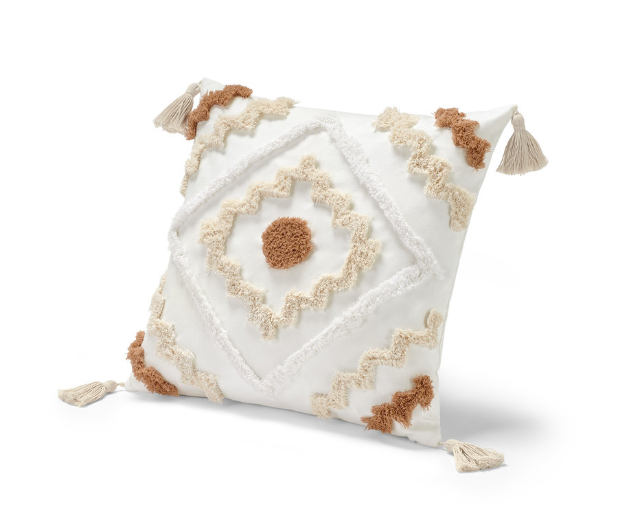 Coussin décoratif blanc d'environ 50 x 50 cm avec motif géométrique et pompons aux coins.