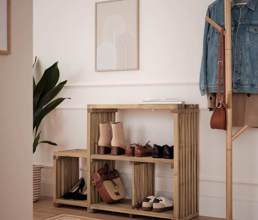 Étagère à chaussures en bambou avec deux étagères avec des chaussures et un sac à main, à côté d'un porte-manteau.