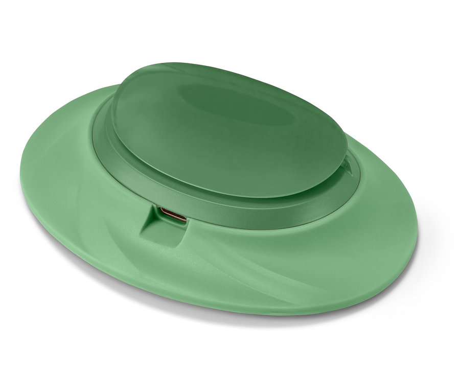 Un distributeur de savon vert sur fond blanc.