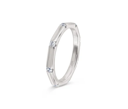 Bague argentée avec trois pierres claires serties.