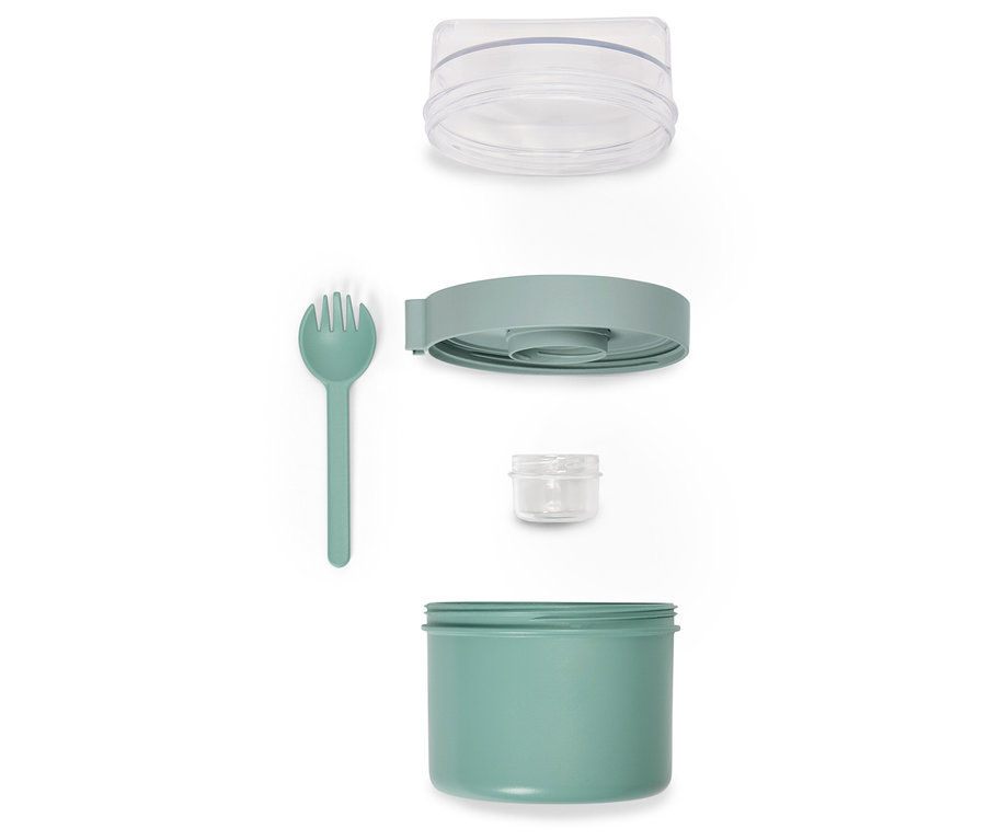 Boîte à déjeuner verte démontée avec fourchette et couvercle transparent.