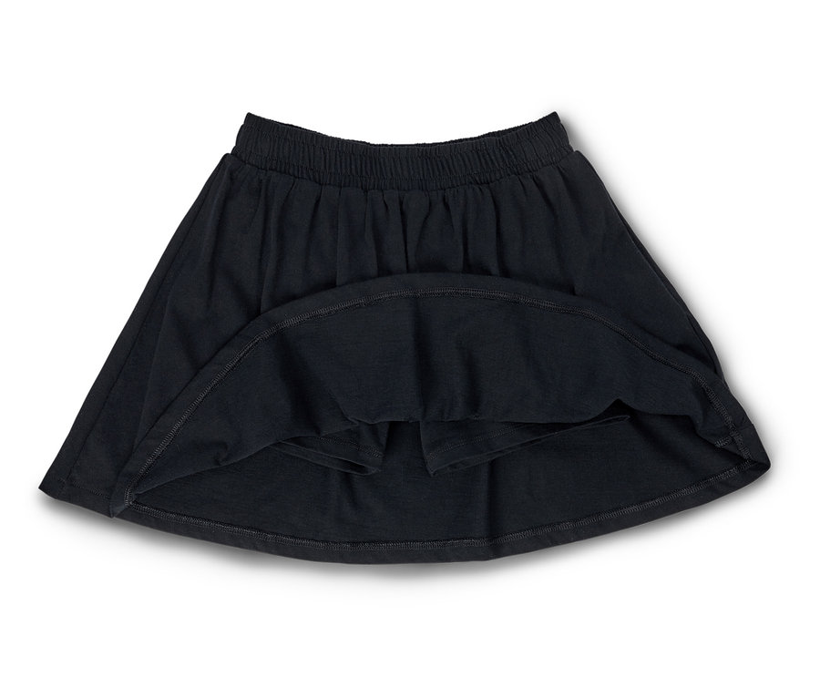 Une jupe noire avec une taille élastique est posée sur un fond blanc.