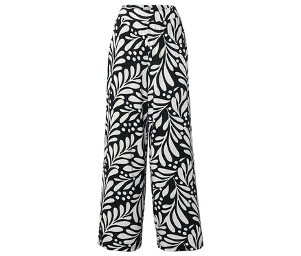Pantalon noir avec motifs de feuilles et de points blancs.