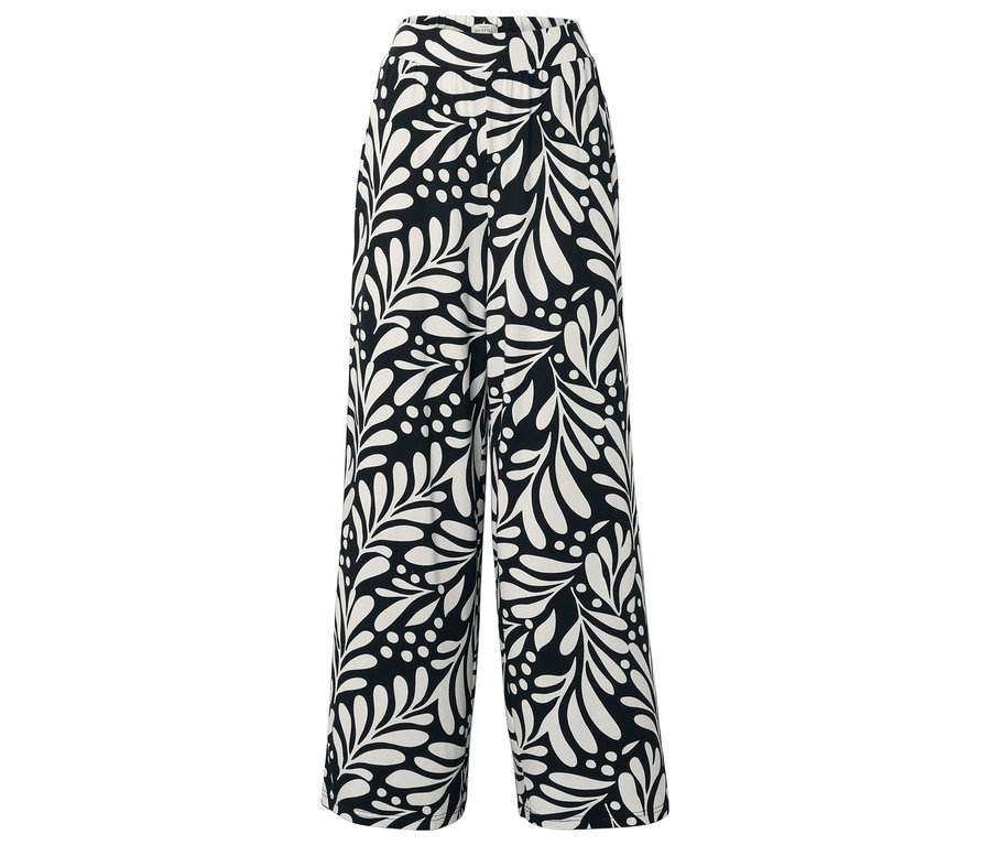 Pantalon noir avec motifs de feuilles et de points blancs.