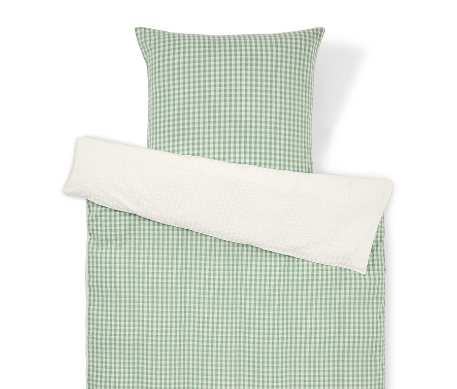 Vue de dessus d'un ensemble de literie à carreaux verts et blancs avec une taie d'oreiller blanche.