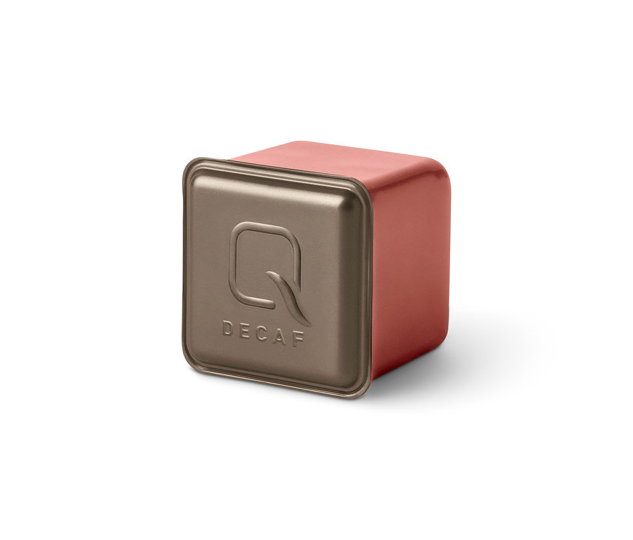 Gros plan sur une capsule Qbo Caffè MENOS CAFEÍNA avec l'inscription DECAF.