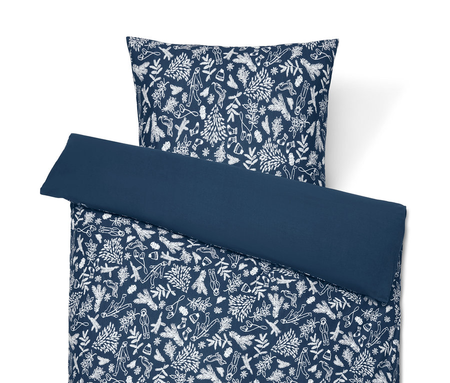 Parure de lit bleu en jersey hivernal avec motif de Noël blanc.