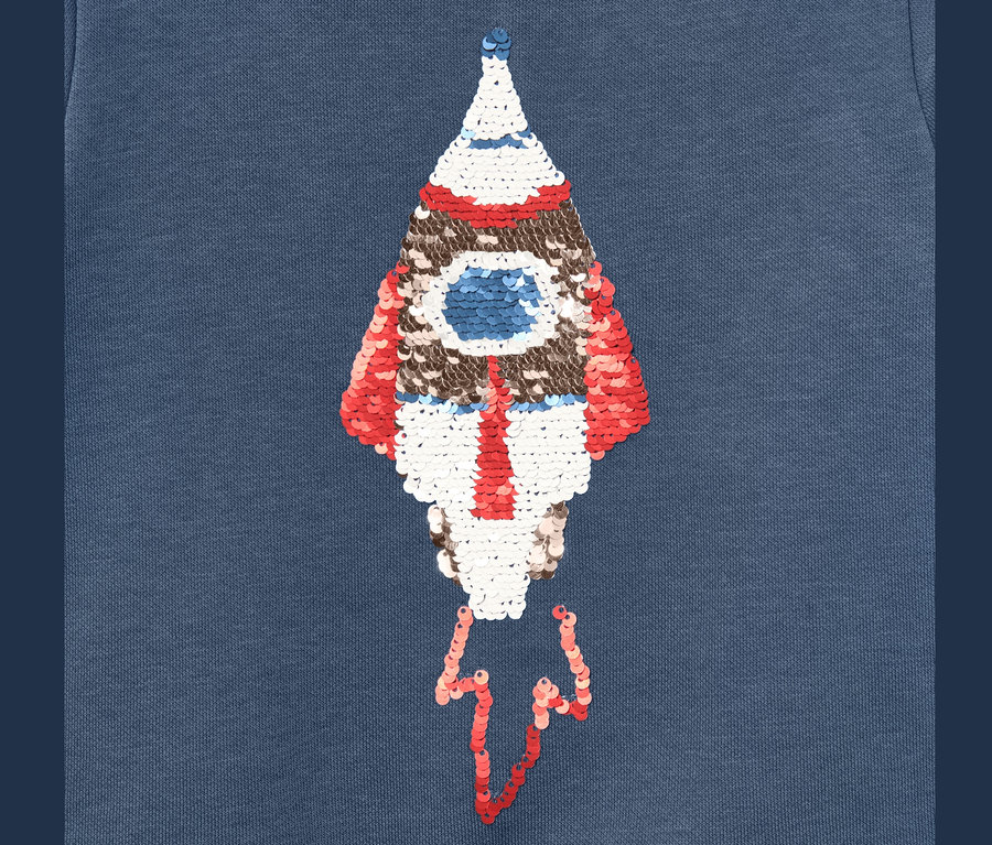 Sweat-shirt bleu pour enfant avec motif de fusée à paillettes réversibles.