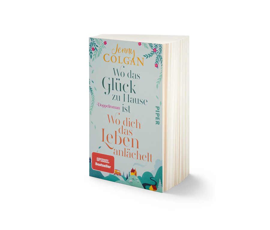 Le livre Double roman « Wo das Glück zuhause ist » et « Wo dich das Leben anlächelt » de Jenny Colgan est posé sur la table.