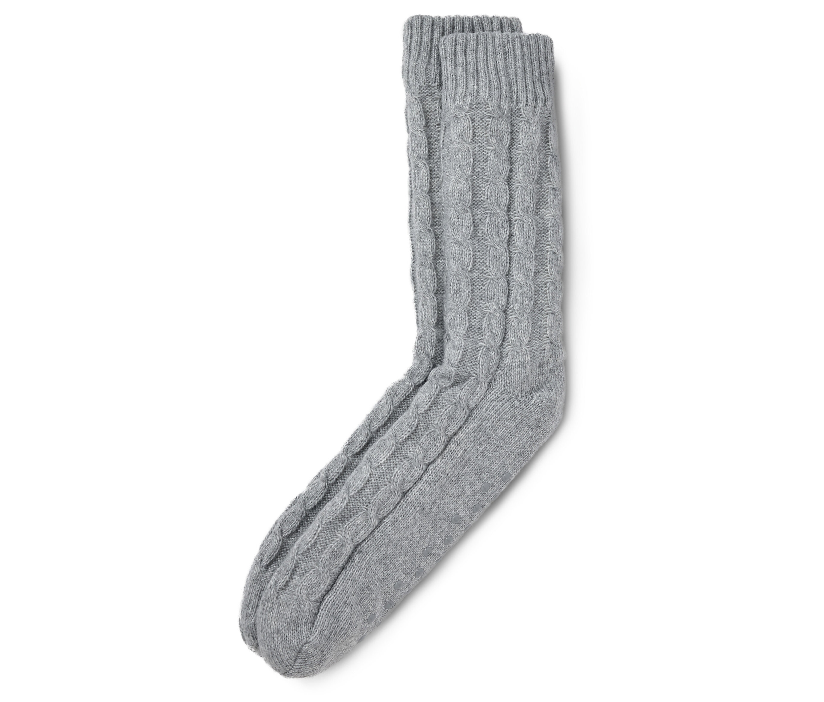 Des chaussettes d'intérieur grises à motif torsadé sont posées sur un fond blanc.