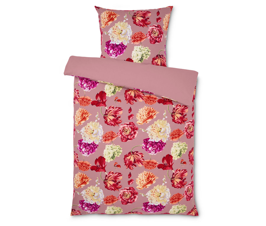 Linge de lit avec motif floral sur fond rose.