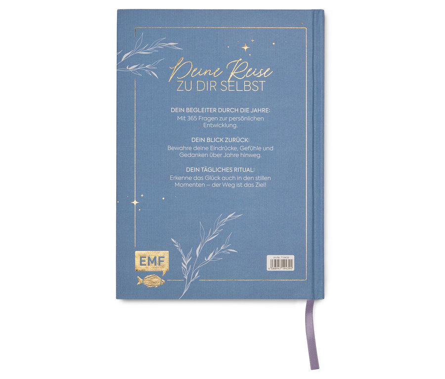 Un agenda bleu intitulé « Votre voyage vers vous-même » avec un marque-page argenté.
