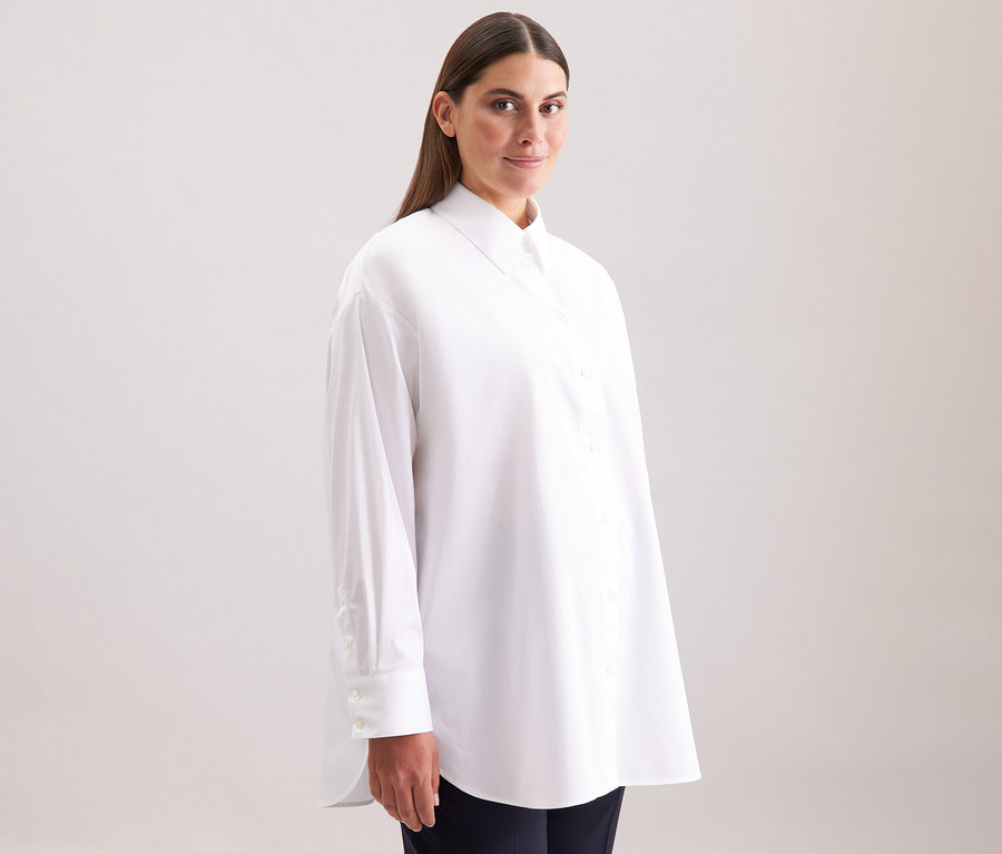 Femme portant une blouse-chemise blanche grande taille Seidensticker.
