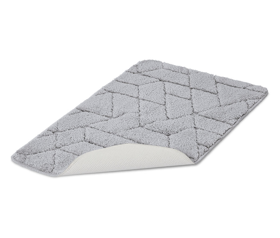 Tapis de bain gris avec motif géométrique et dessous antidérapant.
