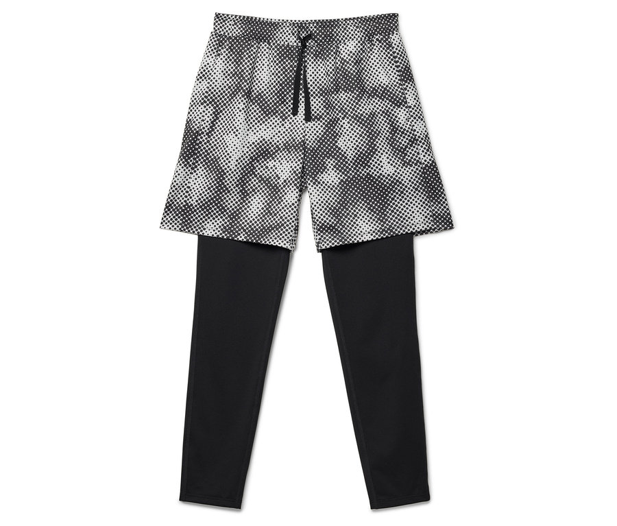 Leggings noirs avec short à pois superposé.