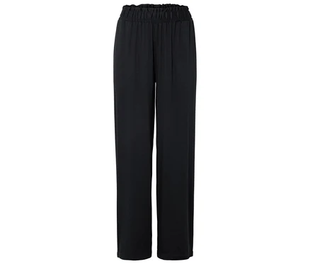 Un long pantalon noir avec une taille élastique est étalé sur un fond blanc.