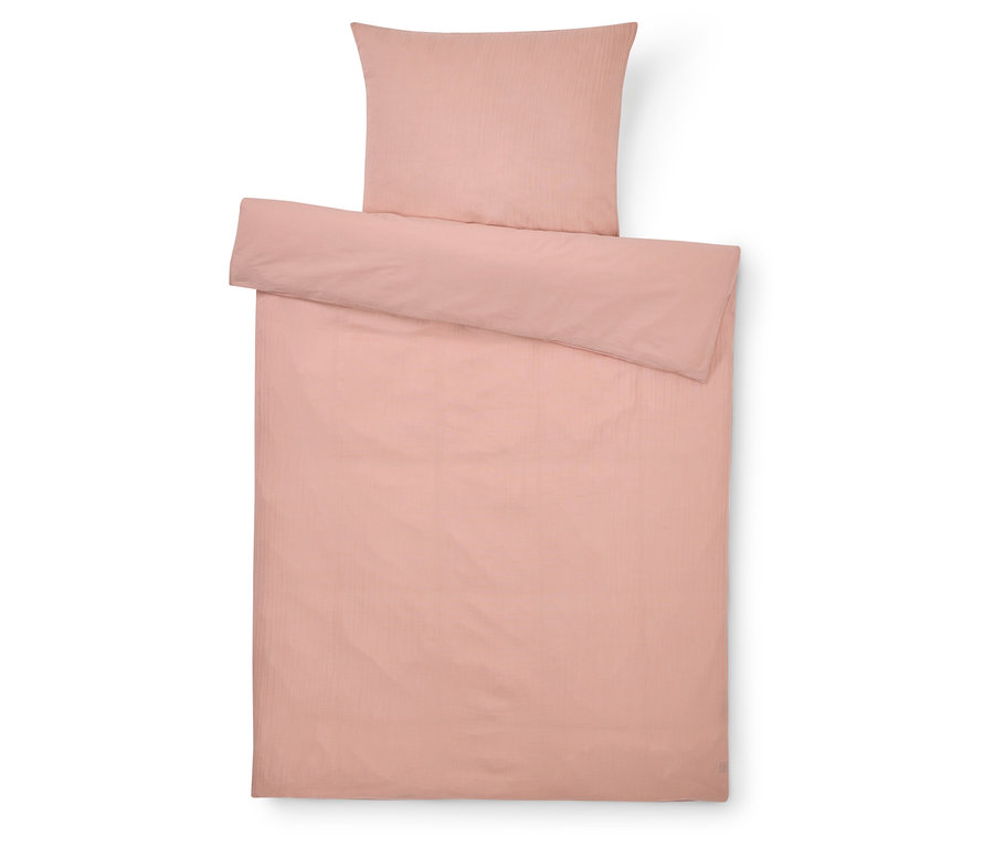 Vue de dessus d'une parure de lit rose comprenant une taie d'oreiller et une housse de couette.