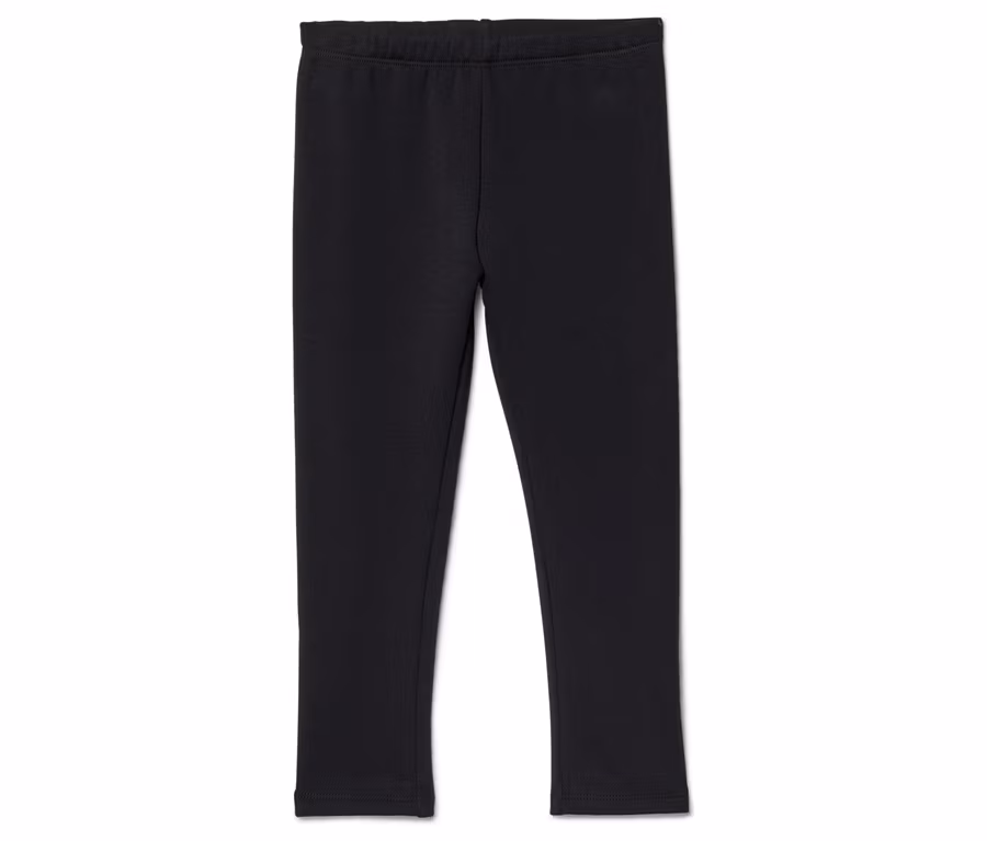 Un legging noir à taille élastique posé sur un fond blanc.