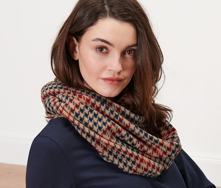 Femme portant une écharpe-tube à carreaux en polaire.