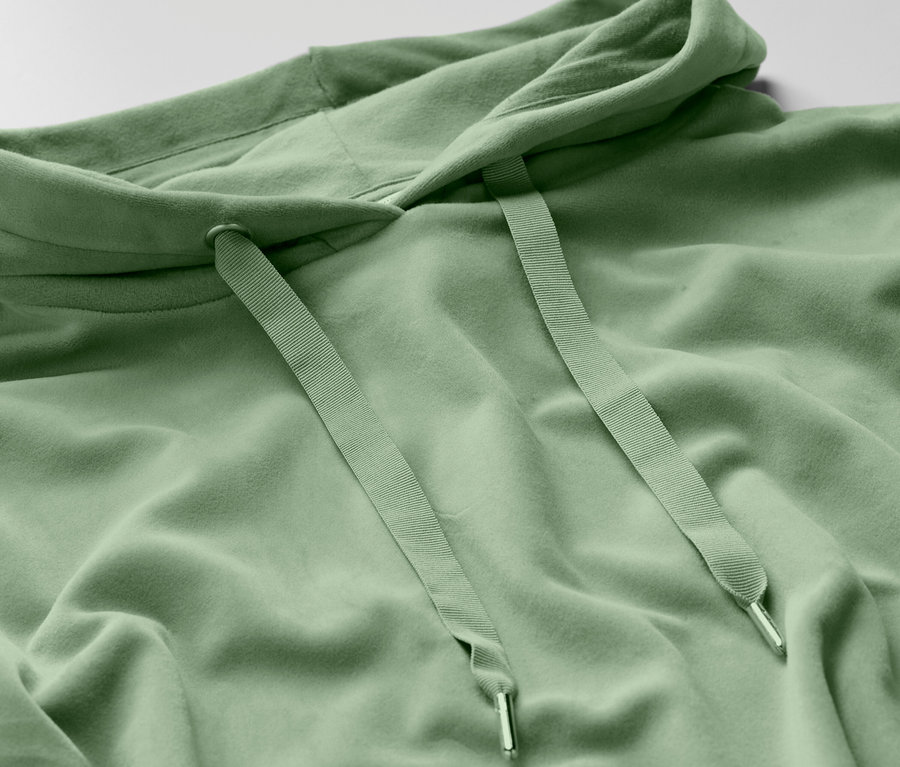 Vue détaillée d'un sweat à capuche vert clair avec cordon de serrage.