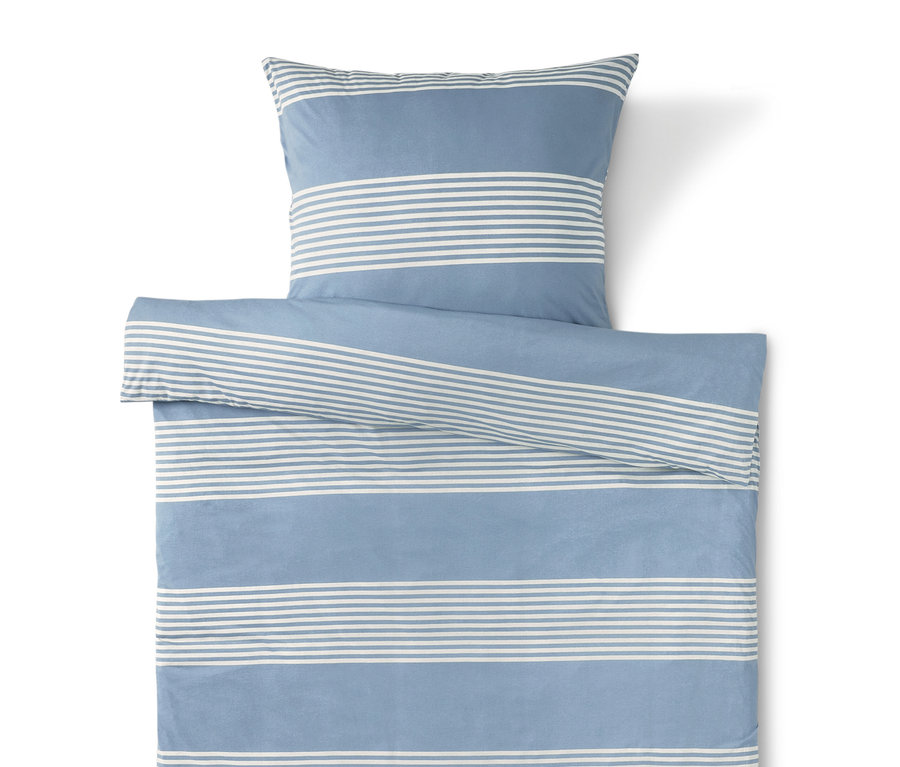 Linge de lit bleu rayé blanc avec taie d'oreiller sur le dessus.