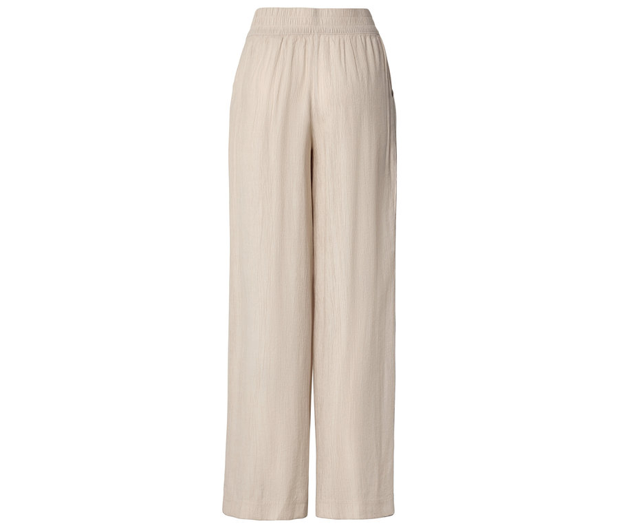 Pantalon beige à jambes larges avec taille élastique.
