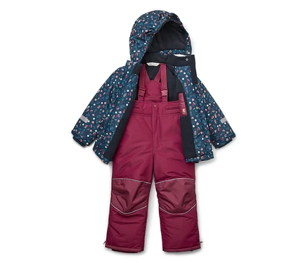 Combinaison de ski 2 pièces pour enfant: veste bleu foncé à motifs floraux et pantalon salopette bordeaux.