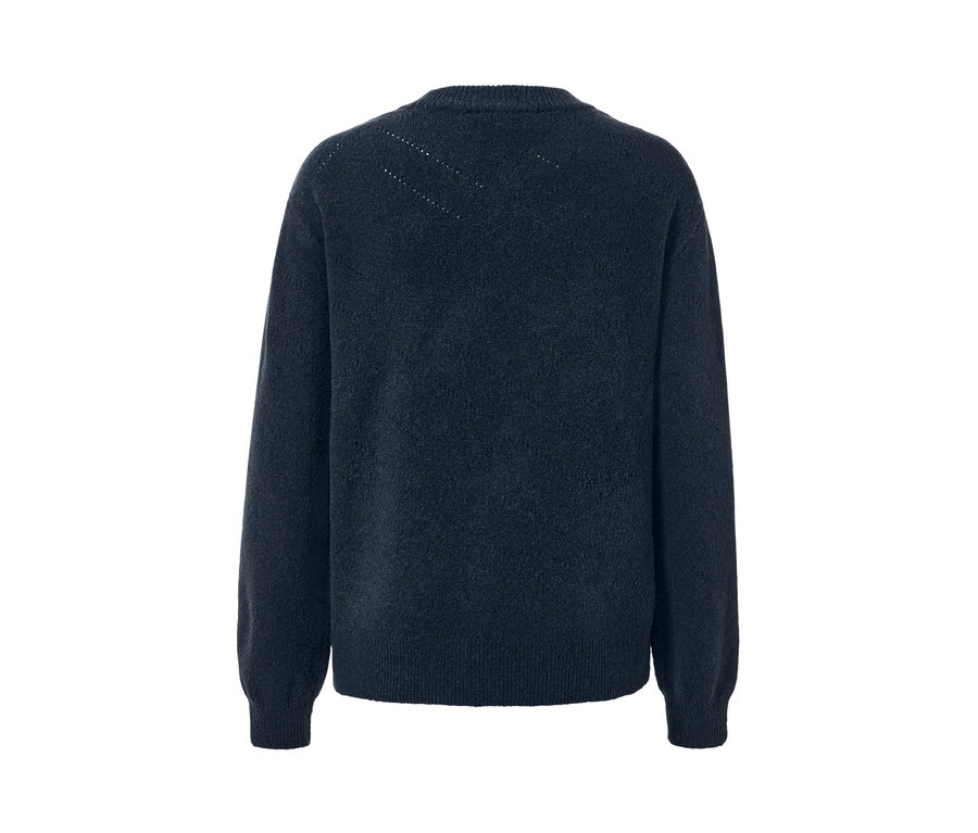 Gros plan d'un pull en maille à motif ajouré.