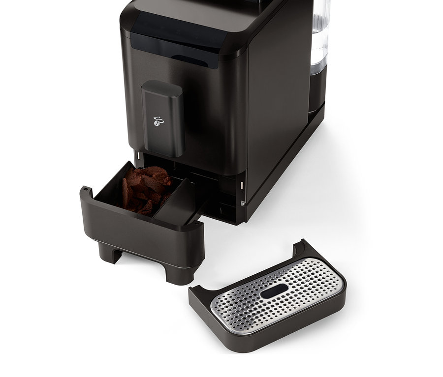 Gros plan sur la machine à café entièrement automatique « Esperto2 Caffè » Granite Black avec le récipient à marc de café et le bac d'égouttement retirés.