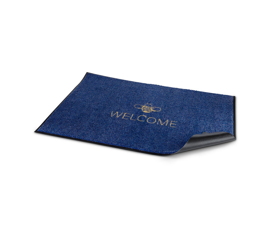 Un paillasson bleu avec l'inscription "WELCOME".