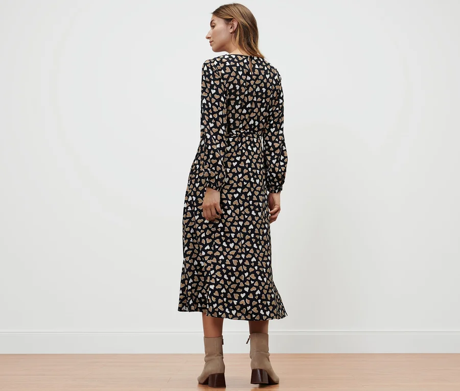 Une femme, vue de dos, porte une robe tissée à imprimé intégral.