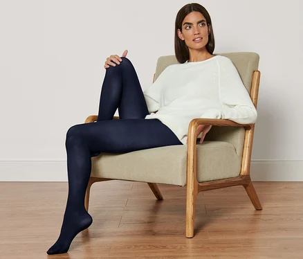 Femme assise dans un fauteuil portant 2 paires de collants fins.