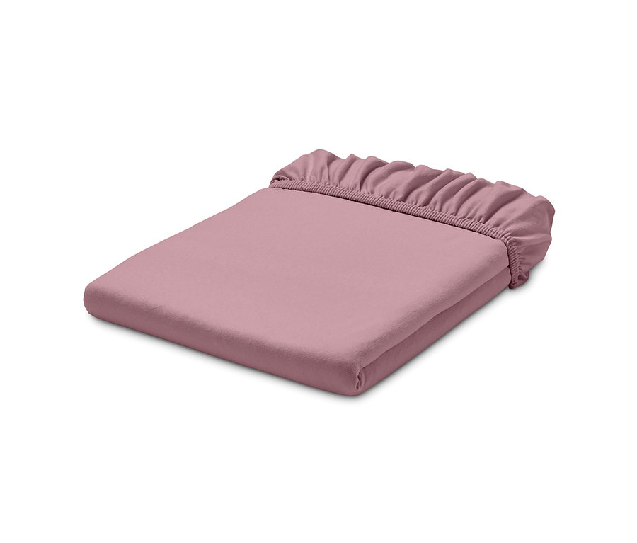 Drap-housse en jersey rose plié.
