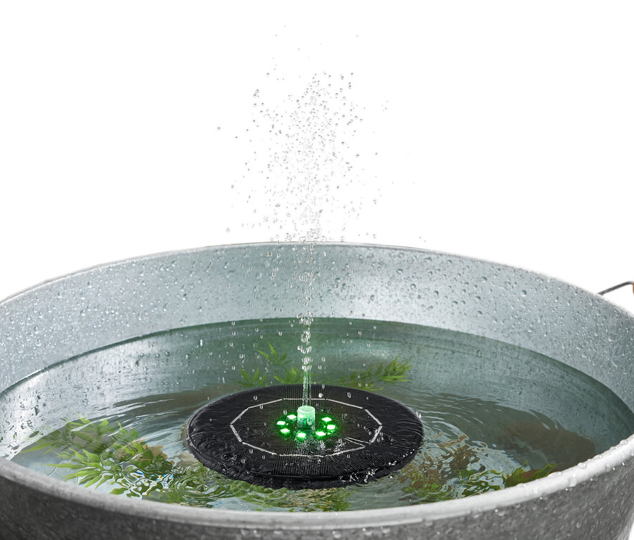 Fontaine flottante à énergie solaire avec éclairage dans l'eau dans un seau en métal.