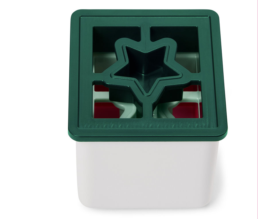 Détail d'un ornement vert en forme d'étoile sur un fond blanc.