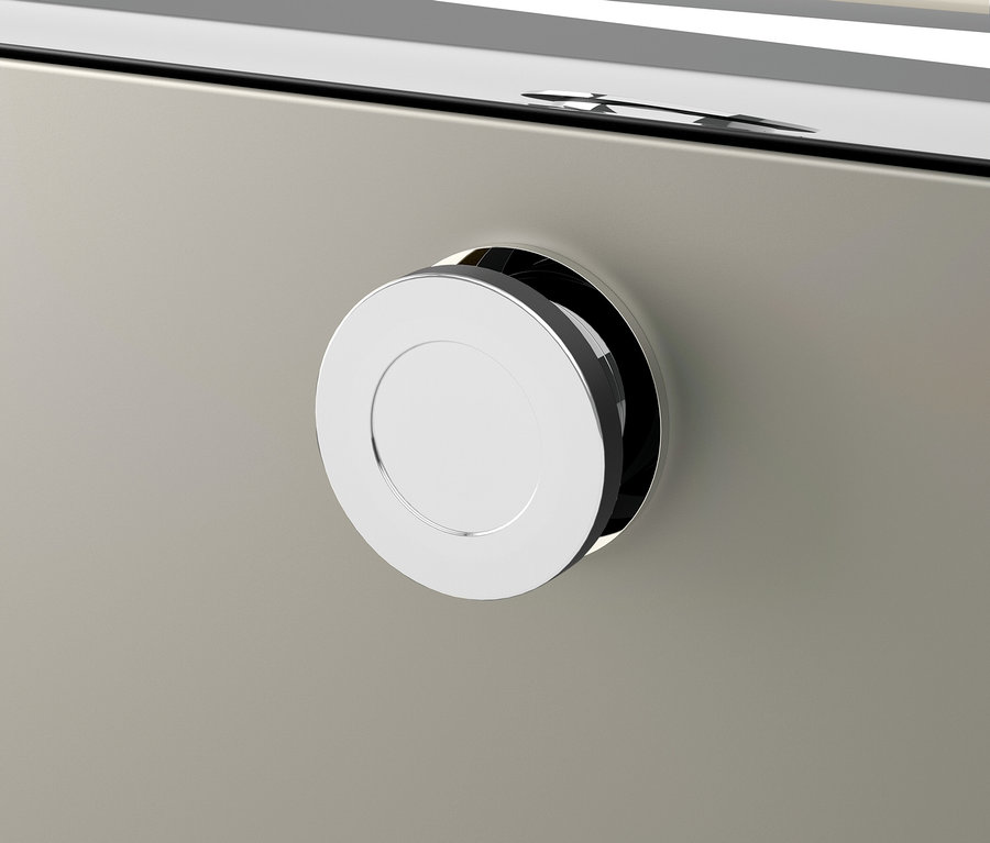 Détail d'un tiroir avec une poignée ronde argentée.