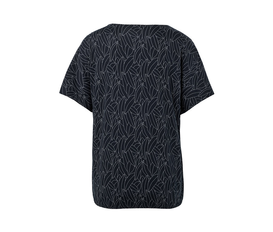 Chemisier à encolure dégagée bleu foncé avec motif de feuilles blanches.