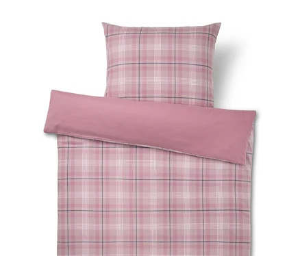 Housse de couette et taie d'oreiller à carreaux roses avec des lignes blanches et gris foncé, surmontées d'un traversin rose uni.