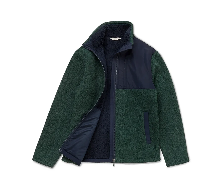 Veste polaire verte et bleu marine avec fermeture éclair, partiellement ouverte.