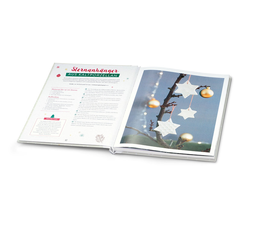 Livre ouvert « Weihnachtsbasteln », avec des étoiles et des boules dorées.