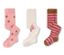 Trois paires de collants roses : une paire à pois marron, une paire avec un personnage de dessin animé et une paire à rayures marron et rose.