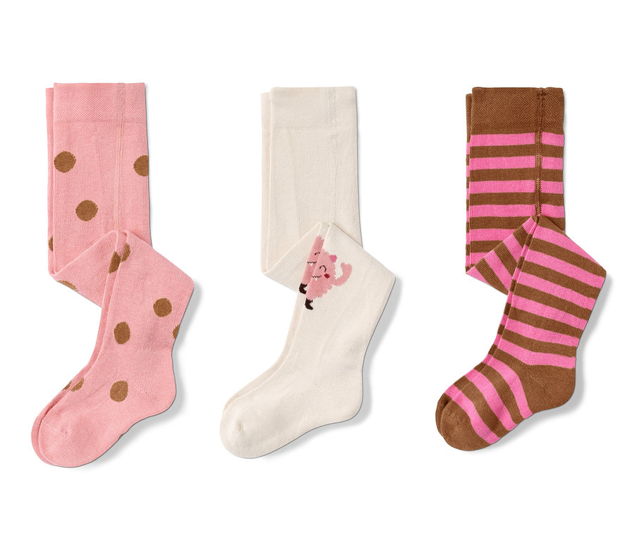 Trois paires de collants roses : une paire à pois marron, une paire avec un personnage de dessin animé et une paire à rayures marron et rose.