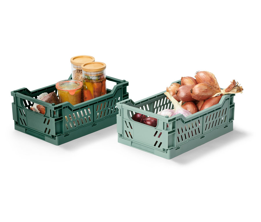 Deux boîtes de rangement pliables, une verte avec des bocaux de conserve, une vert clair avec des oignons et de l'ail.