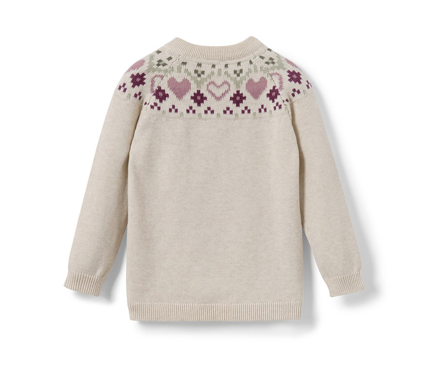 Gros plan sur un pull en maille pour enfant avec un motif norvégien.