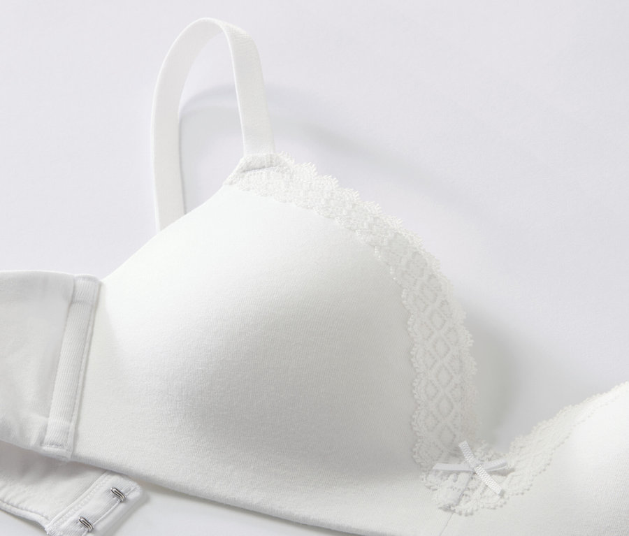 Gros plan d'un soutien-gorge blanc à coques souples avec de la dentelle.