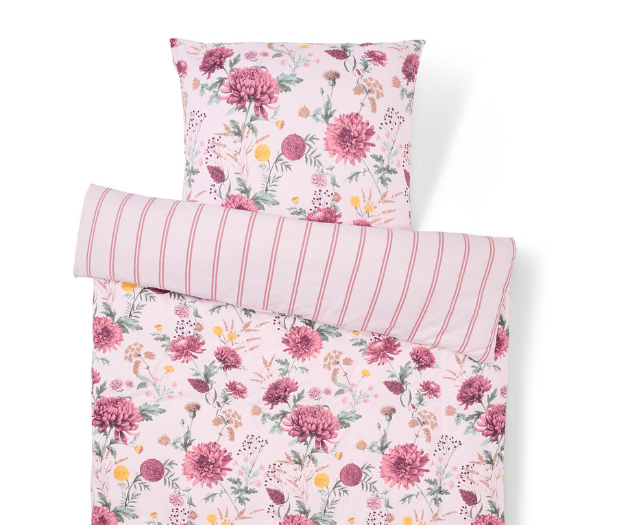 Linge de lit à motif floral avec un oreiller rayé.