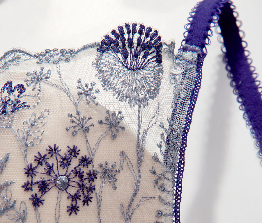 Vue détaillée du soutien-gorge plongeant à armatures « Chloe » Passionata avec broderie florale bleue.